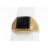 A 9ct gold gents signet ring, with central rectangular black agate panel, with fanned design shoulde