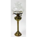 A Victorian style brass oil lamp, with large dome glass top and flute, on reeded column and a steppe