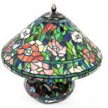 A Tiffany style table lamp, heavily decorated with flowers, with metal mounts and electrical fitting