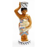 A Villeroy and Boch candle stand, depicting an African lady carrying a leopard cub, 27cm high.