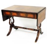 A 20thC flame mahogany sofa table, the top with a moulded outline raised above two real and two dumm