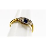 An Art Deco style dress ring, the central design set with square cut sapphire and two tiny diamonds,