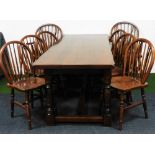 A 19thC style oak refectory table and eight (6+2) hoop back chairs, each chair with stick backs, tur