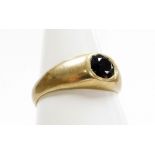 A 9ct gold dress ring, with central garnet in a rub over setting, ring size R, 3.5g all in.