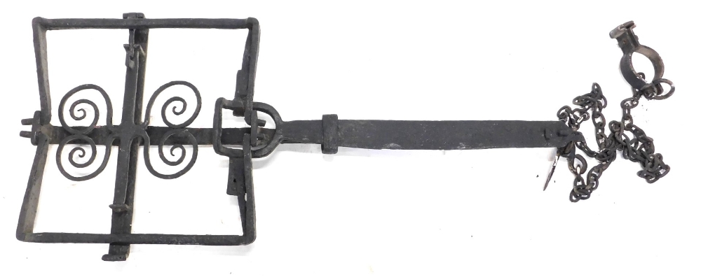An antique wrought iron ornamental man trap, of rectangular form, with scroll decoration, 104cm wide