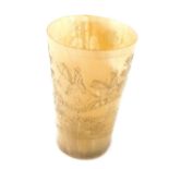 A 19thC horn beaker, of tapering cylindrical form with later carving of a hunting scene with huntsma