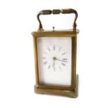 An early 20thC brass repeating carriage clock, of rectangular form with swing handle, the five part