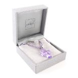 A lilac Lalique crucifix pendant, on a purple rope twist string, the pendant 2.5cm high, boxed.