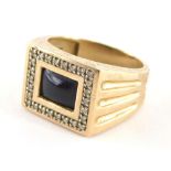 A 9ct gold gents signet ring, with central black stone set panel, surrounded by tiny diamonds, with