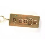 A 9ct gold ingot pendant and chain, the ingot Sheffield 1977 on curb link chain, yellow metal unmark