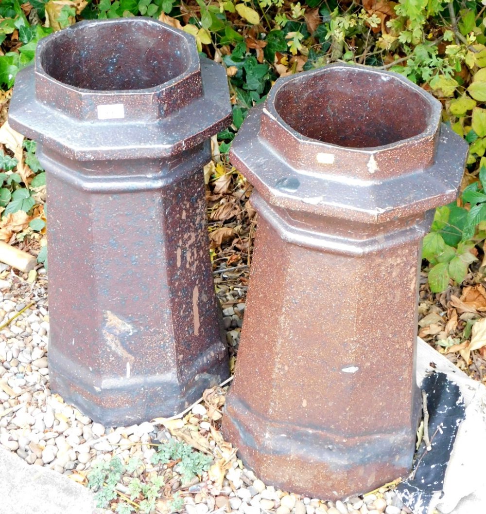 A pair of 20thC fire clay chimneys, each with octagonal collars, 70cm high. (2)
