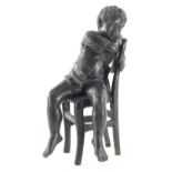 A bronze figure of child, seated on chair, unsigned, 35cm high.