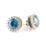 A pair of blue zircon and diamond cluster earrings, each centred by a round cut zircon totalling app