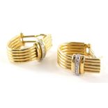 A pair of 18ct gold hoop earrings, each hoop formed of five bars, with a diamond set clip, matching