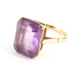 An amethyst dress ring, with central rectangular cut amethyst 18mm x 15mm, in a raised four claw mou