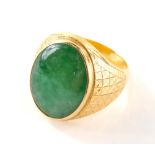 A Chinese jade signet ring, the large oval jade centre 20mm x 15mm, in a rub over setting, with hatc