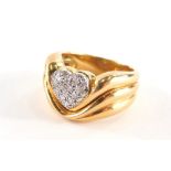 A diamond pavè set dress ring, with central heart emblem with pavè set round brilliant cut diamonds,