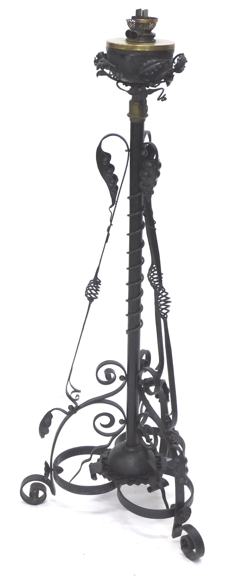 A late 19thC/early 20thC wrought iron floor lamp, with an oil lamp fitting and reservoir, the base d