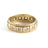 A diamond set eternity ring, with central tiny diamond in illusion white gold setting, with outer ye