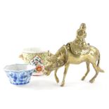 A Chinese brass figure group, of a child on the back of a buffalo, with removable saddle, 14cm high,