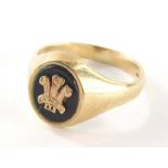 A 9ct gold gents signet ring, with black agate panel and raised fleur de lis, marked CYMRU, ring siz