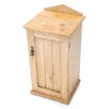An early 20thC pine pot cupboard, with panel door on squat feet, 79cm high, 36cm wide, 32cm deep.