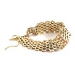 A 9ct gold gate bracelet, of five and four bar design, with two loops and safety chain, 19cm long, 1
