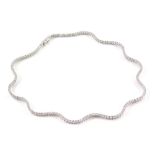 A Wempe diamond waveline necklet, set with one hundred and sixty six graduated round brilliant cut d