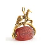 A silver agate fob, with a figure of a horse on wishbone, with three sided orange agate swivel fob,