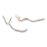 A pair of Wempe diamond waveline earrings, each earring set with thirty three graduated diamonds, in