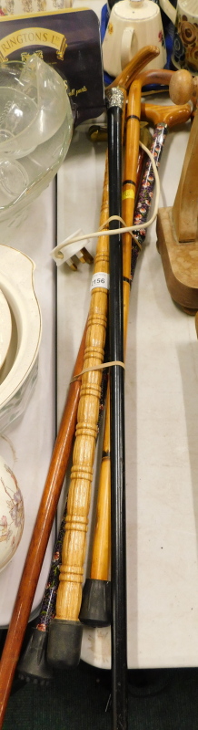 Walking sticks, to include horse head example, another with silver top of ebonised tapering form, et