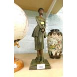 A spelter figure of a standing lady holding golf club.
