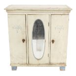 An early 20thC painted pine doll's triple wardrobe, with an out swept pediment over three doors, the