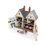 An doll's house with extensive contents, over three various floors with dining suite, bedrooms, and