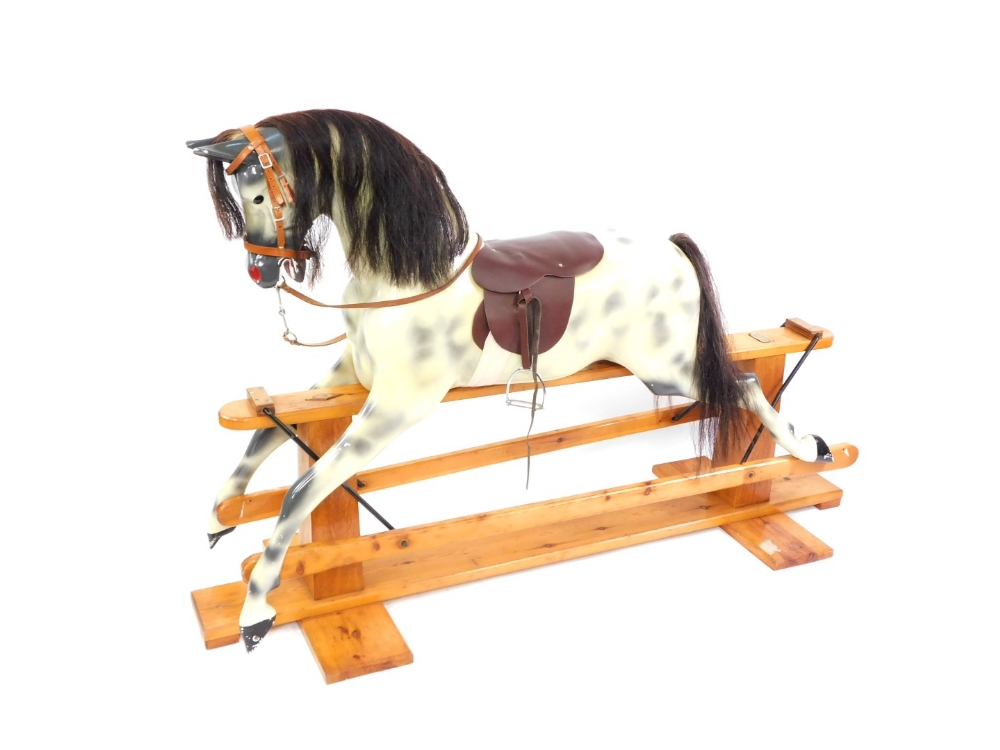 A Haddon Rockers rocking horse, the dappled horse with a maroon leather seat, on a pine base with Ha