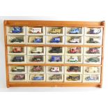 A group of models of Yesteryear vans, in a pine display case, thirty cars, all boxed.