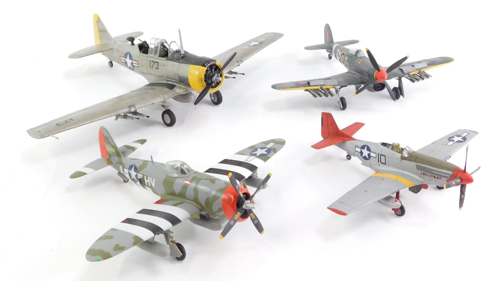 Four built and painted model aircraft, including a Spitfire, and three USAAF planes.