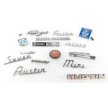 A group of British car badges, to include the Mini 1000, Austin 7, the Allegro MG red enamel badge,