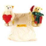 A Steiff I Love You XX Teddy bear holding a heart, together with a Steiff Christmas Teddy bear holdi