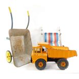 A Mighty Tonka hydraulic dumper truck, child's pushchair and a child's wheelbarrow. (3)