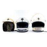 Three motorcycle helmets, comprising a Kangol white helmet, a BFE Bieffe helmets white crash helmet