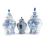 A pair of Chinese 20thC porcelain vases and covers, of baluster form, decorated in blue and white wi