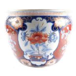 A Chinese Republic Imari porcelain goldfish bowl, decorated with reserves of flowers, against floral