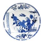 A Chinese blue and white porcelain charger, with open scroll decoration with peonies emerging from r