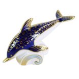 A Royal Crown Derby dolphin paperweight, riding the wave, gold stopper, 18cm wide, boxed.