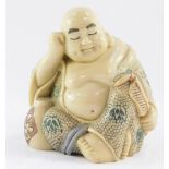 A resin figure of a seated Buddha, 11cm high.