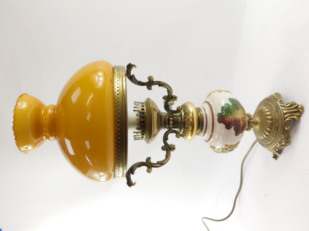 A 20thC oil lamp style electric table lamp, with orange glass shade on a brass three prong support, - Image 2 of 4