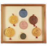 Seven replica resin great seals, comprising Elizabeth I, The Commonwealth, Scotland, Anne, Charles I