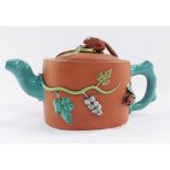 A Chinese redware teapot, with animal finial, carrying berries on vines and a bat, with turquoise ha