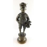 A Continental late 19thC bronze figure of an urchin boy, modelled standing holding a food sack, on a